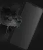 A black phone case is shown with a dark, liquid-like substance splashing around it. Produktbild-Vorschau
