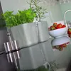 A kitchen counter with herbs in planters, strawberries in a bowl, and a salt and pepper grinder. Náhled obrázku produktu