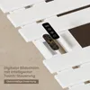 A close-up view of a white electric towel warmer with a remote control and its internal circuit board visible. Produktbild-Vorschau