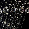 A close-up view of a crystal chandelier with many hanging crystals and strings. Produktbild-Vorschau