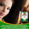 A woman's face and hair are shown next to a bottle of Batana Oil, with promotional text at the bottom. Anteprima dell’immagine prodotto