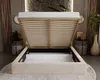 A bed with its storage compartment open, showcasing the slatted base and storage space, in a bedroom setting. Náhled obrázku produktu