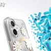 A close-up of a clear phone case with daisy decorations, with a background of blue rod-shaped bacteria. Podgląd zdjęcia produktu