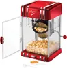 A retro-style red and silver popcorn maker, open with popcorn inside and a small amount of popcorn kernels and a measuring cup in the foreground. Náhled obrázku produktu