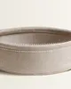 Close-up view of the rim of a round, woven storage basket with visible stitching. Produktbild-Vorschau