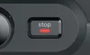 A close-up of a stop button on a dark gray appliance, with the word 'stop' and a red indicator light illuminated. Anteprima dell’immagine prodotto