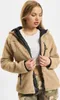 A woman wearing a beige teddy fleece jacket. Produktbild-Vorschau