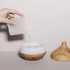 A hand is pouring water into an ultrasonic humidifier. Podgląd zdjęcia produktu