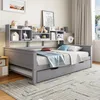 A gray daybed with a bookshelf headboard is set up in a bedroom with a rug and curtains. Náhled obrázku produktu