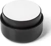 A close-up studio shot of a single black furniture foot with a white top. Produktbild-Vorschau