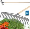 A rake is shown against a white background, with a pile of grass and leaves in the foreground. A tag indicating 'Made in EU' is attached to the rake. Podgląd zdjęcia produktu