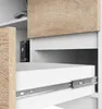 A close-up view of a white drawer with a metal slide mechanism, part of a desk with a wood-grain textured surface. Produktbild-Vorschau