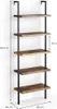 A tall, narrow bookshelf with a rustic wood finish and black metal frame, shown against a white wall. Náhled obrázku produktu