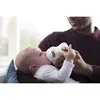A father is feeding his baby with a bottle. Podgląd zdjęcia produktu