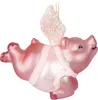 A pink glass ornament of a flying pig with angel wings and glitter accents, suspended by a gold chain. Voir les images du produit