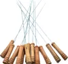 A collection of BBQ skewers with wooden handles, arranged in a fanned-out pattern against a white background. Produktbild-Vorschau