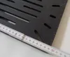 A close-up of a black metal grate with a measuring tape laid across it. Náhľad obrázku produktu