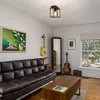 A living room with a couch, coffee table, guitars, and a window. Náhľad obrázku produktu