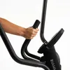 A close-up shot of a person's hands gripping the handlebars of an elliptical trainer. Podgląd zdjęcia produktu