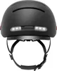 A black bicycle helmet with integrated white LED lights on the back and black straps. Náhled obrázku produktu