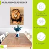 A framed picture of a lion hanging on a wall above a dining table. Produktbild-Vorschau
