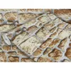 A roll of wallpaper with a stone brick pattern. Produktbild-Vorschau