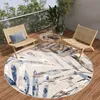 A round rug with a leaf pattern is placed on a wooden deck on a balcony, with two chairs and a coffee table.