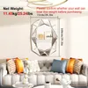 A decorative mirror is hung above a sofa with several pillows. Voir les images du produit