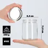 A hand holding a lid above a glass jar, with measurement indicators and icons showing weight and diameter. Produktbild-Vorschau