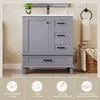 A grey bathroom vanity with a white countertop, featuring drawers and a cabinet, set against a neutral wall. Below the vanity are four circular icons with text. Anteprima dell’immagine prodotto