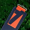 A close-up of a phone case with a strap, set against a backdrop of green foliage. Náhľad obrázku produktu