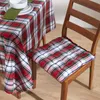 A close-up of a chair with a plaid cushion and a table with a matching plaid tablecloth. Náhled obrázku produktu