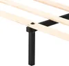 A close-up view of a bed frame's wooden slats and black metal support leg. Produktbild-Vorschau