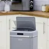 A close-up of a gray retro-style trash can with its lid partially open, set in a kitchen environment. Podgląd zdjęcia produktu