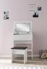 A white vanity table with a mirror and a black stool in front of it, set against a light pink wall. Produktbild-Vorschau