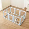 A blue dog playpen with transparent windows is set up on a wooden floor in a room. Two corgis, an adult and a puppy, are inside the playpen. Produktbild-Vorschau