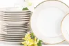 A stack of white and gold rimmed plates and bowls, with yellow and white flowers in the foreground. Náhľad obrázku produktu