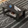 A modern coffee table with a shelf, a laptop, and a mug on a patterned rug. Produktbild-Vorschau