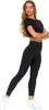 A woman wearing black leggings and a black crop top, posing against a white background. Produktbild-Vorschau