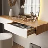 A close-up view of a white and wood vanity table with an open drawer filled with makeup organizers and products. Podgląd zdjęcia produktu