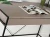 A close-up of a desk with a magazine and a phone on it. Voir les images du produit