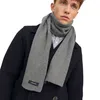 A man wearing a dark coat and a gray scarf. Anteprima dell’immagine prodotto