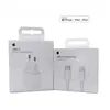 Two white product boxes for Apple accessories, a power adapter and a cable, are shown side-by-side against a white background. Produktbild-Vorschau