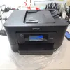 A black Epson WorkForce Pro WF-4820DWF printer is shown on a desk. Náhled obrázku produktu
