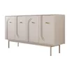 A beige sideboard with four doors and gold handles, standing on wooden legs, isolated on a white background. Produktbild-Vorschau