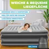 A woman lying on an inflatable mattress in a room. Produktbild-Vorschau