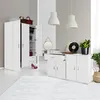 A white kommode with drawers and doors, styled in a modern room with decorative items. Náhľad obrázku produktu