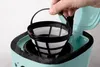 A hand is shown inserting a coffee filter basket into a turquoise coffee maker. Anteprima dell’immagine prodotto