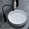 A modern bathroom sink with a black faucet. Anteprima dell’immagine prodotto