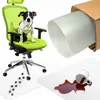 A dog sits on a green office chair, which is placed on a transparent floor mat. A roll of the floor mat is shown in a cardboard box, and a spilled cup of coffee is on another mat. Náhled obrázku produktu